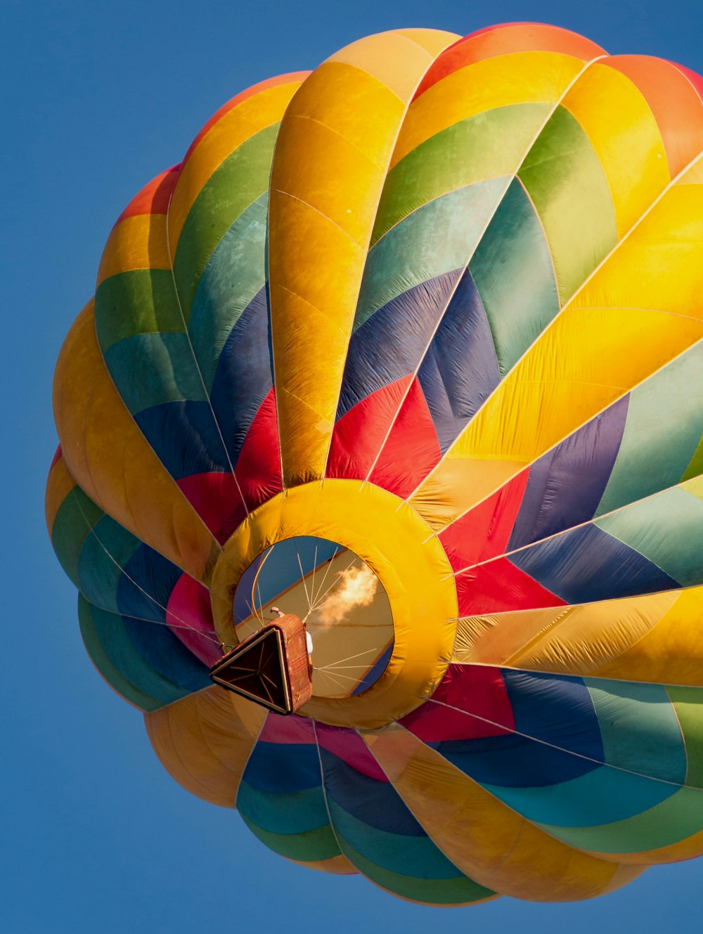 a colorful hot air balloon flying in a blue sky