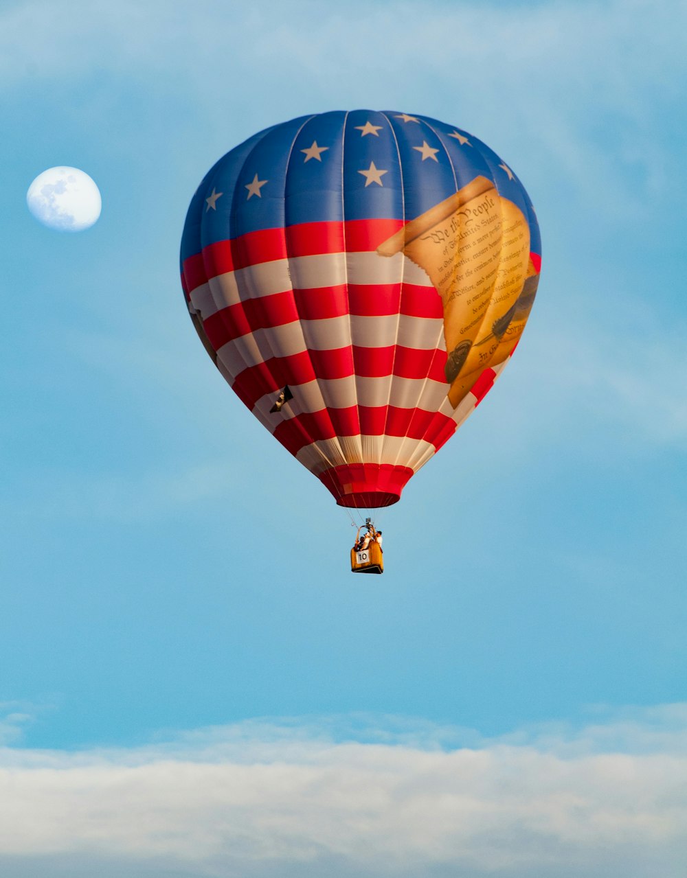 a hot air balloon with the moon in the background