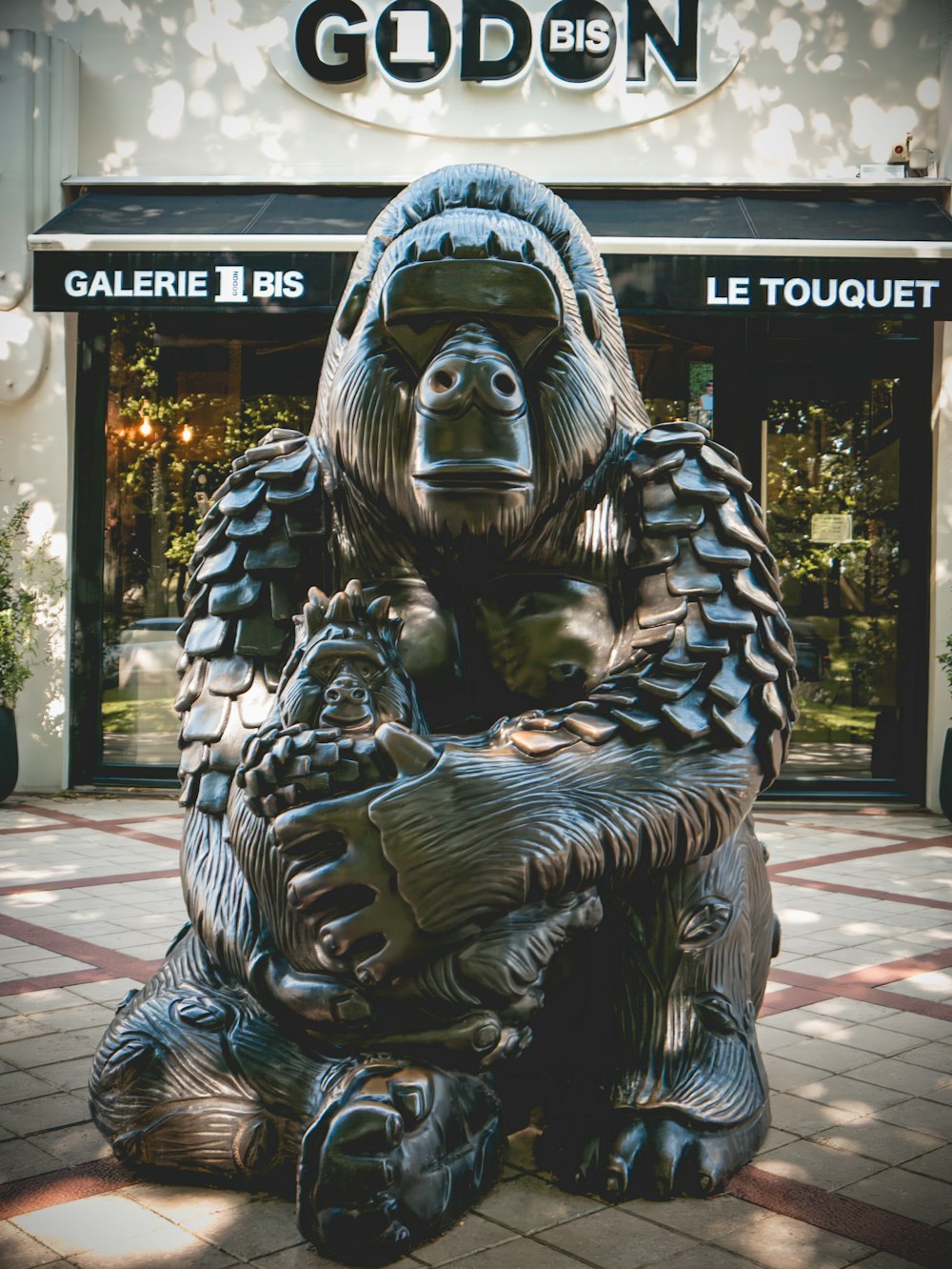 a statue of a gorilla sitting in front of a building