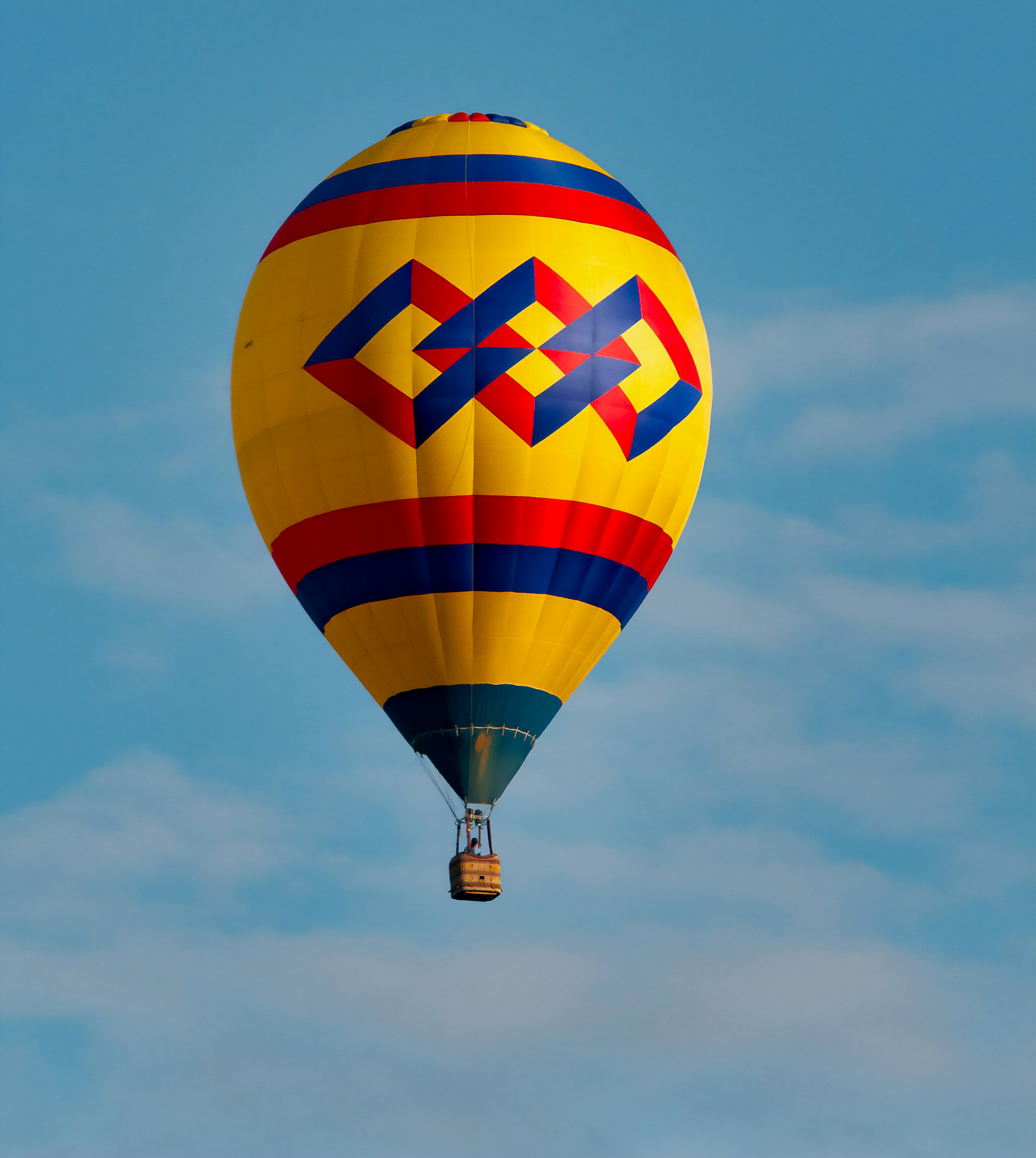 A colorful hot air balloon flying through a blue sky photo – Free Blue ...