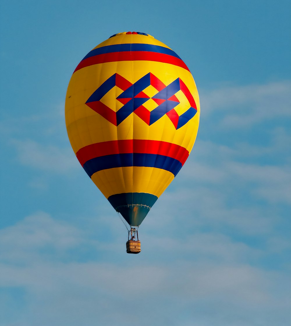 a colorful hot air balloon flying through a blue sky