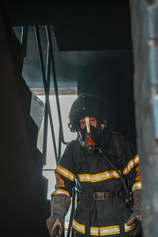 Firefighter training simulation with a masked figure wearing a limited visibility cover.