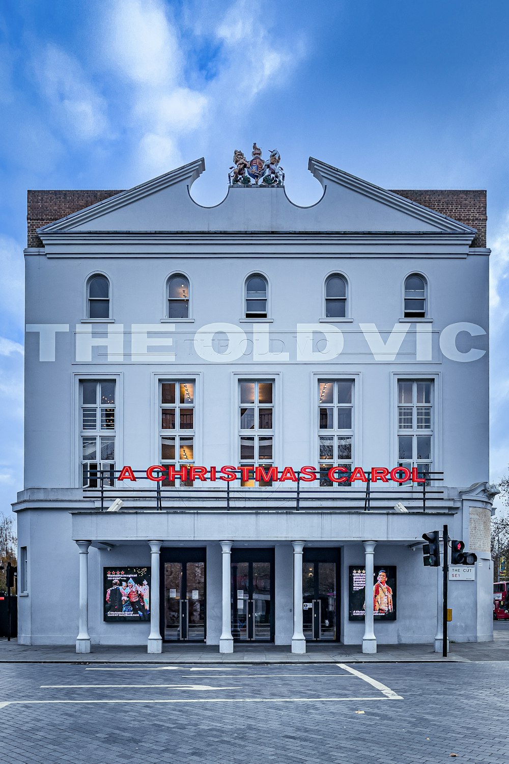 a large white building with red decorations on the roof