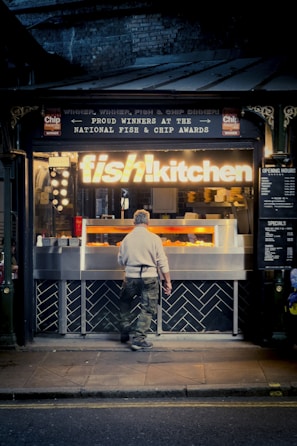 Chef preparing fresh fish chips in the open kitchen.