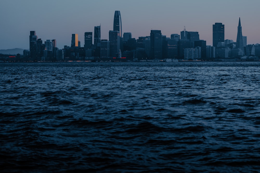 a large body of water with a city in the background