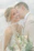 A joyful couple exchanging vows under a floral arch with soft sunlight filtering through.