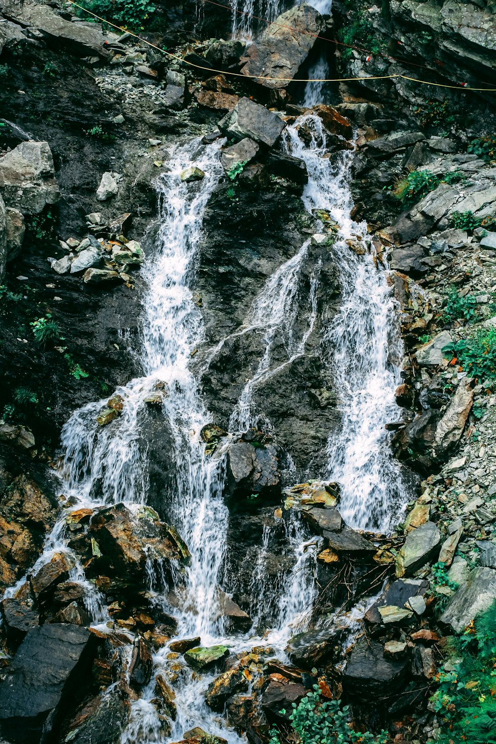 a small waterfall in the middle of a forest