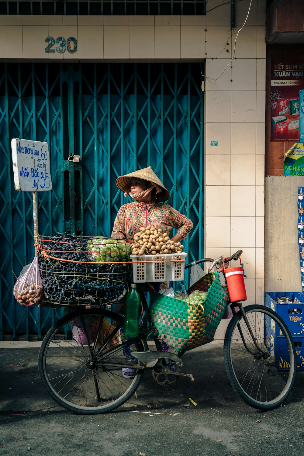 una persona in sella a una bicicletta con un cesto di cibo sul retro