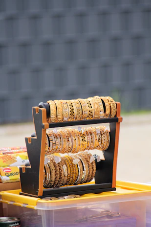 Display of chic accessories including earrings and bangles on marble surface