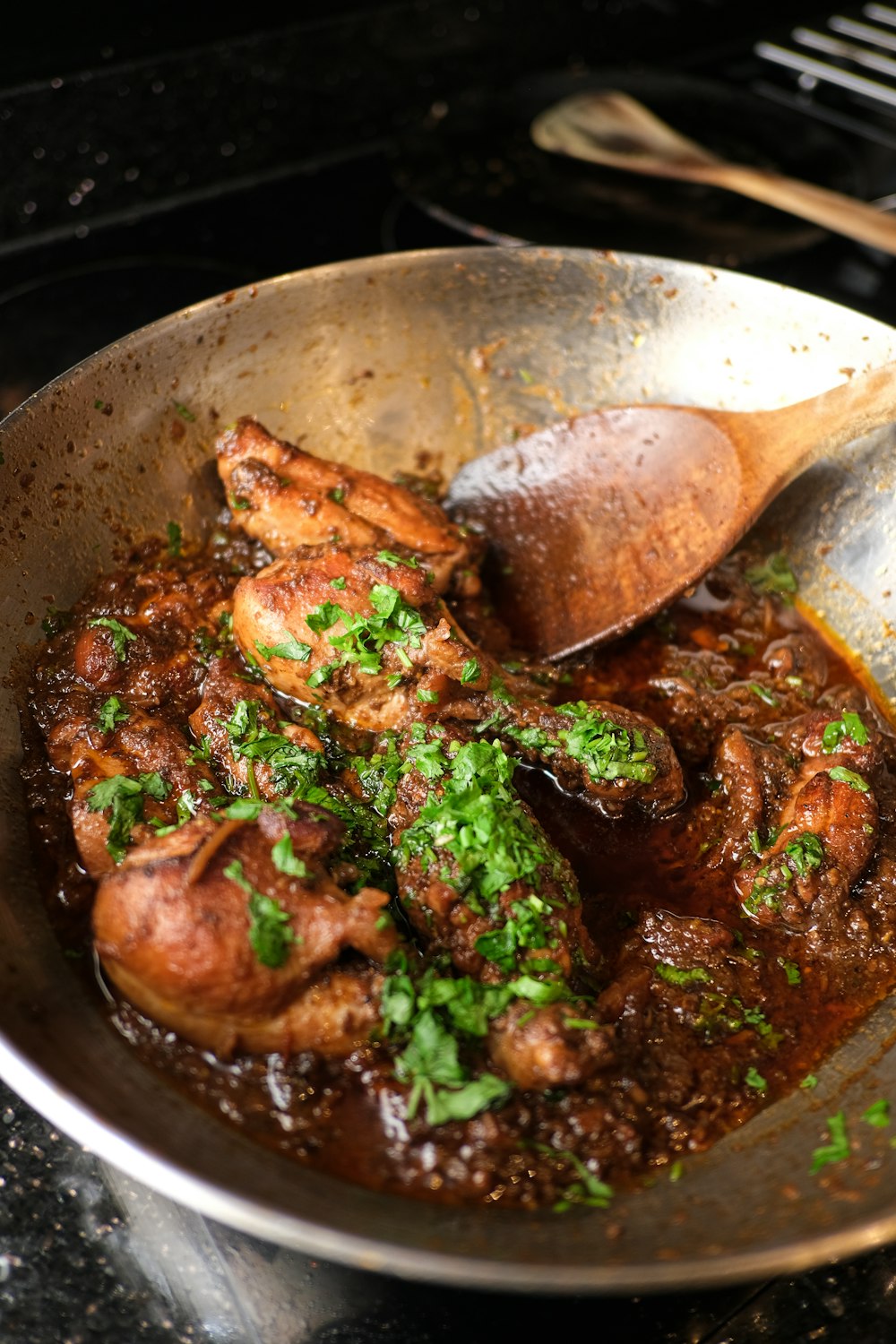 a pan filled with meat and vegetables on top of a stove