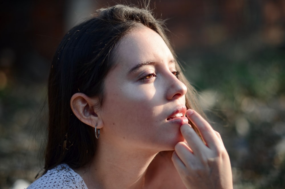 a woman with a cigarette in her mouth