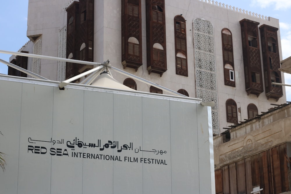 a large white trailer parked in front of a building