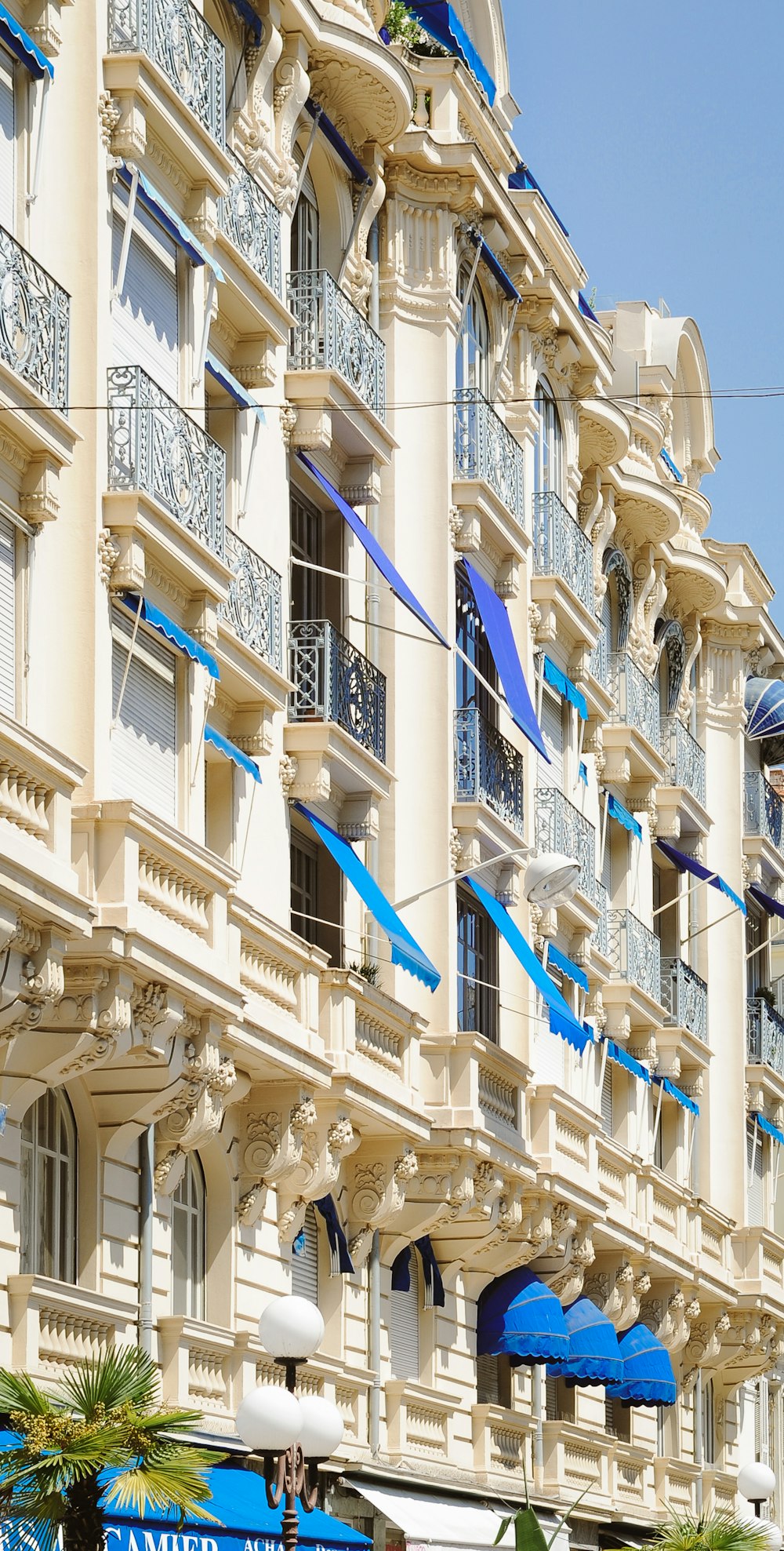 a row of buildings with blue and white balconies