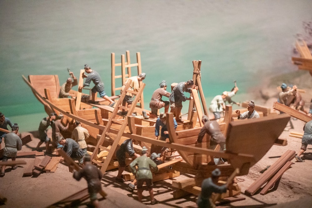 a group of toy figurines of men building a boat
