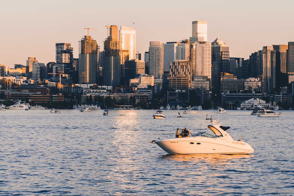 a boat in the water with a city in the background