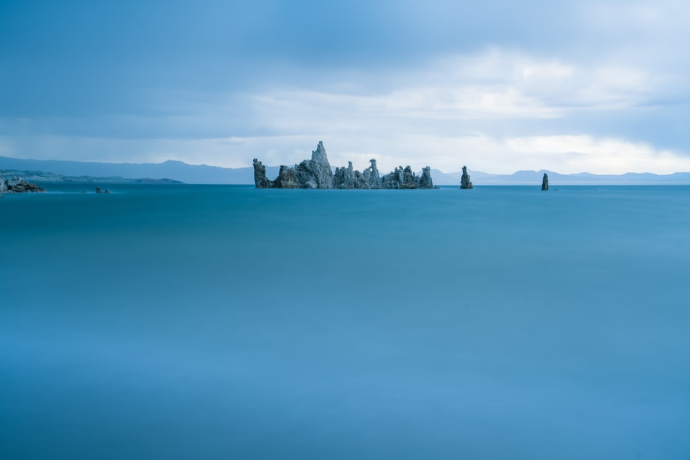 a large body of water with a bunch of rocks in the middle of it