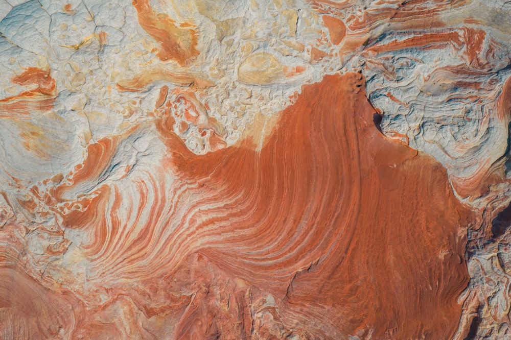 a close up of a red and white rock