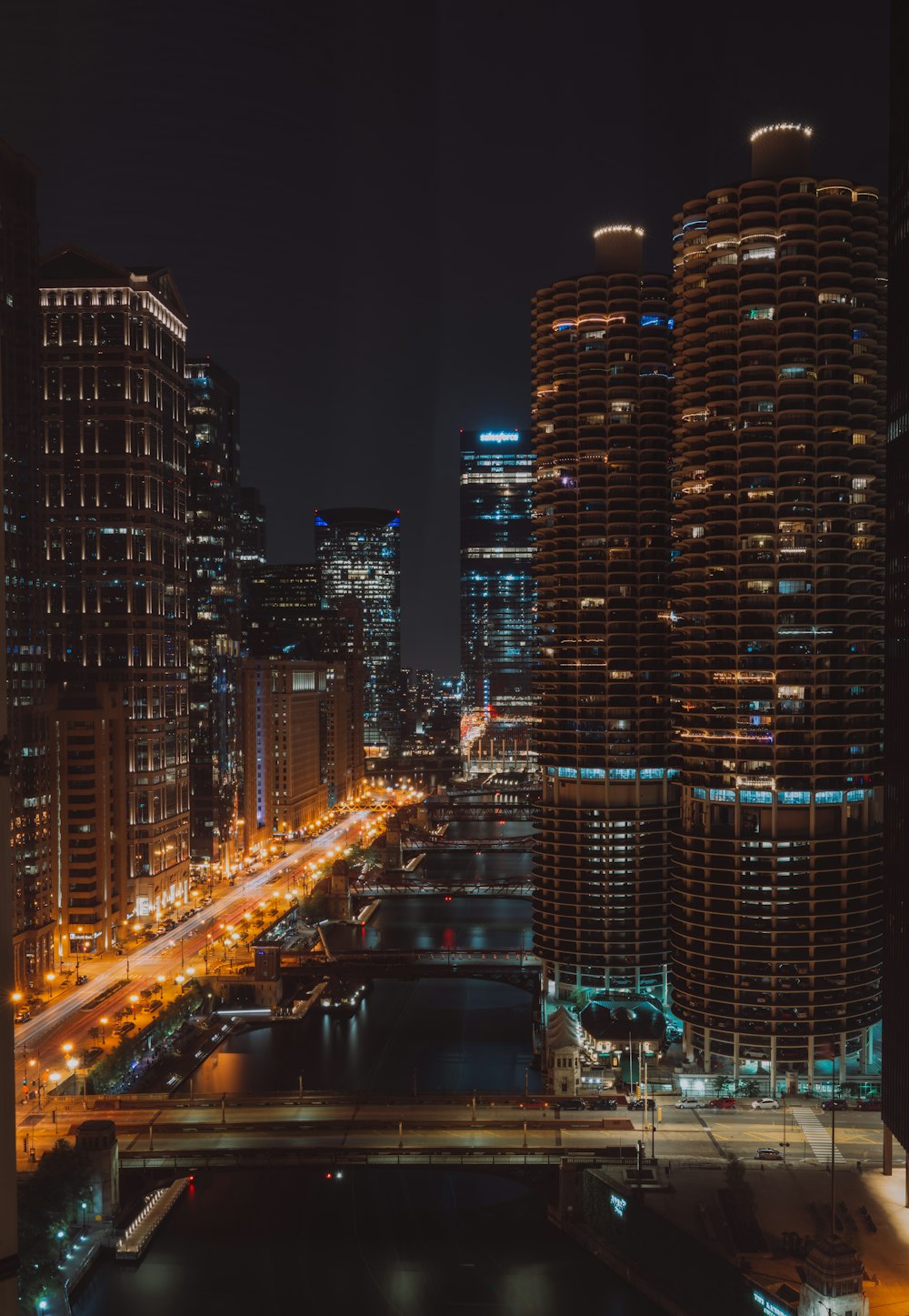 a view of a city at night from a bridge