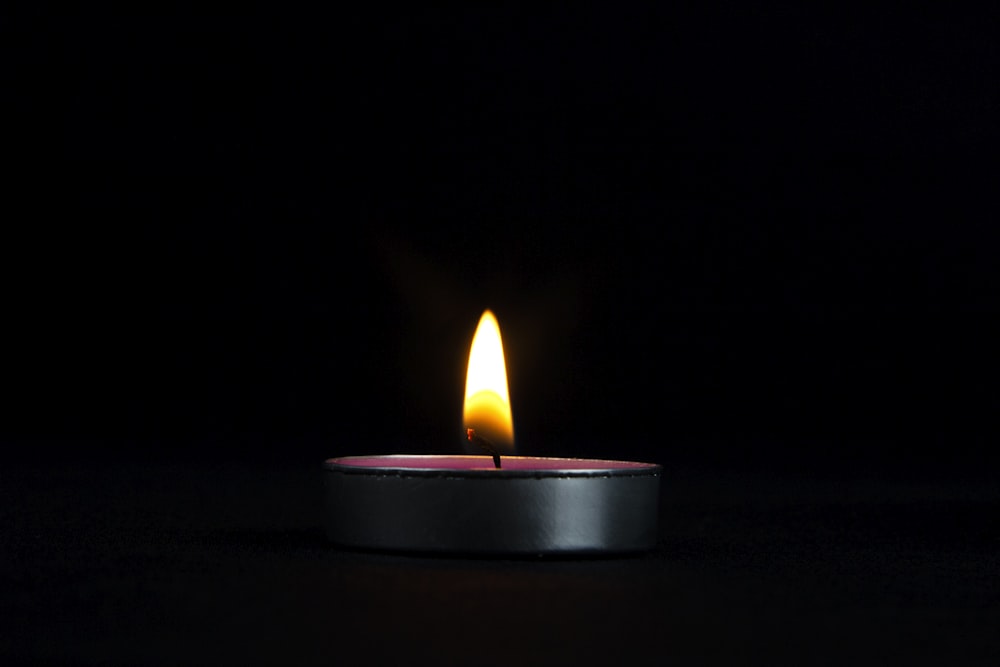 a lit candle sitting on top of a table