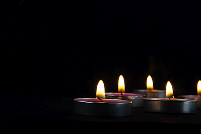 An elegant spa setting with flickering candles and light teal accents, evoking calm and sensual relaxation.