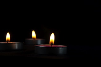 a group of lit candles sitting on top of a table