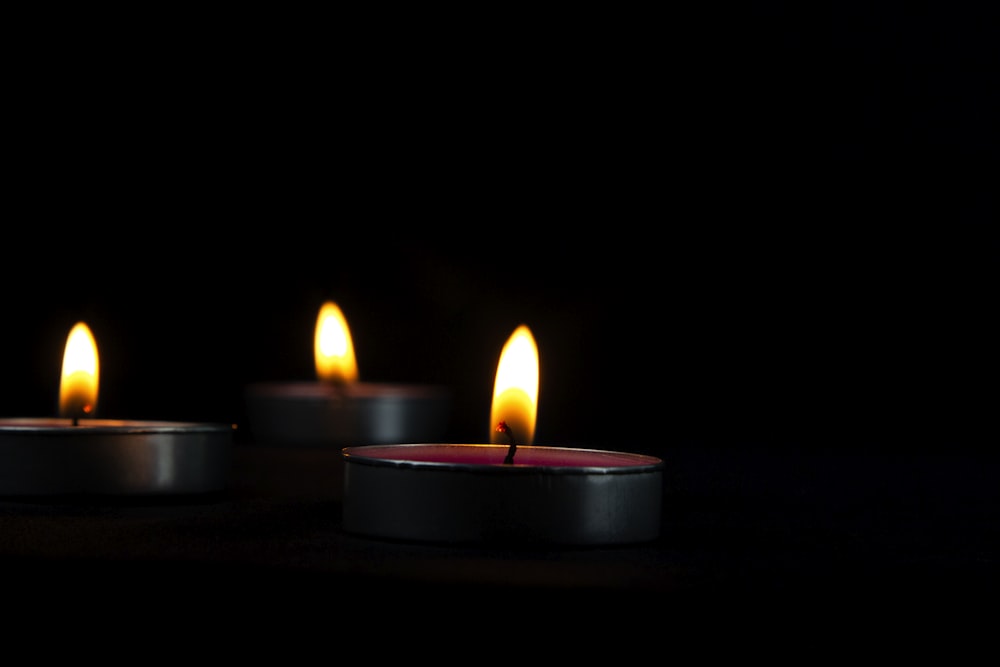 a group of lit candles sitting on top of a table