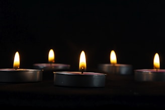 a group of lit candles sitting on top of a table