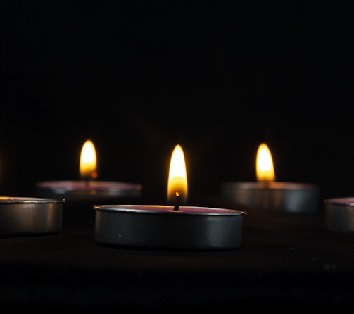 a group of lit candles sitting on top of a table