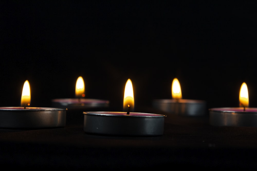 a group of lit candles sitting on top of a table