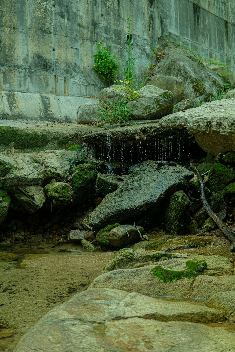 a small stream of water running over rocks