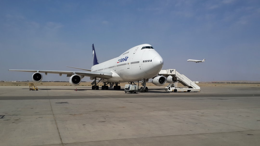 a large jetliner sitting on top of an airport tarmac, Iran air Boeing 747 200 Series at Tehran Imam Khomeini Internation