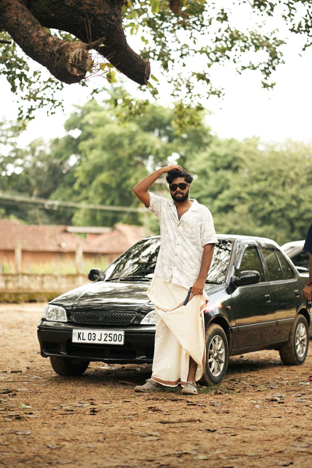 a man standing next to a parked car