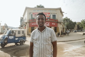 Sushil standing proudly in front of his first business establishment, surrounded by employees