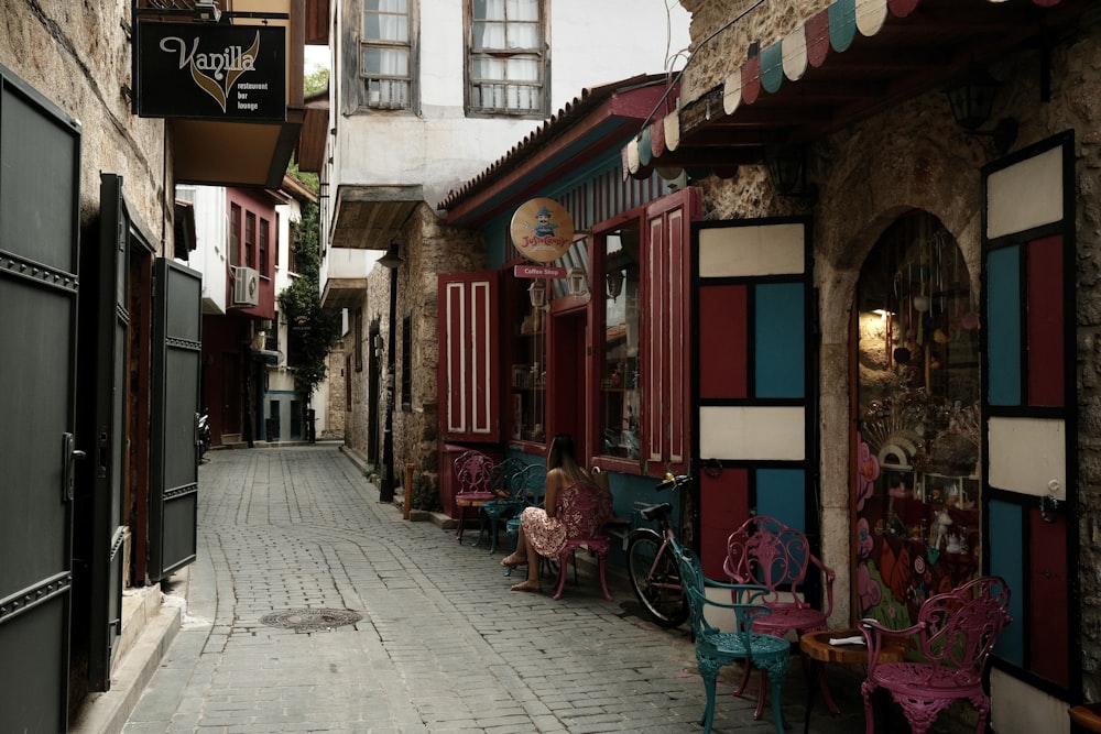 a cobblestone street lined with tables and chairs