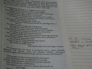 A close-up of handwritten notes and books on theologies of time spread across a desk.