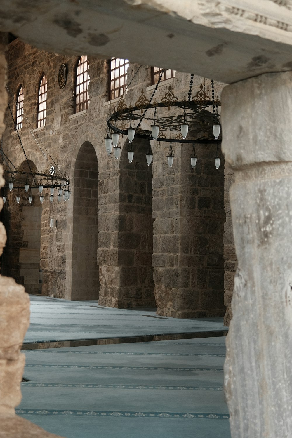 a stone building with a bunch of chandeliers hanging from it's ceiling