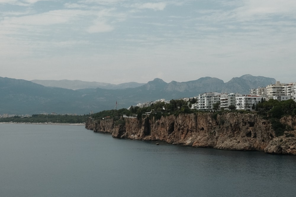 a body of water surrounded by mountains and buildings