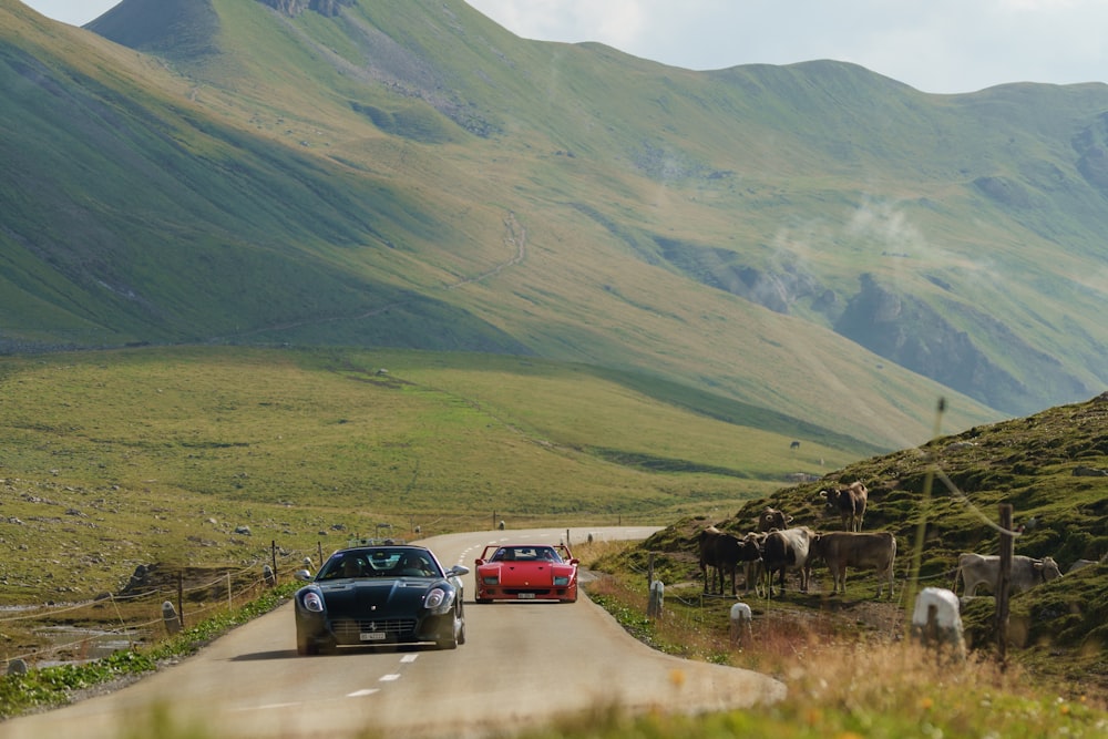 a couple of cars driving down a country road