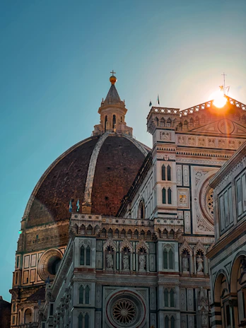 A warm morning view of the Basilica di Sant'Anastasia al Palatino with sunlight highlighting its ancient stone facade.