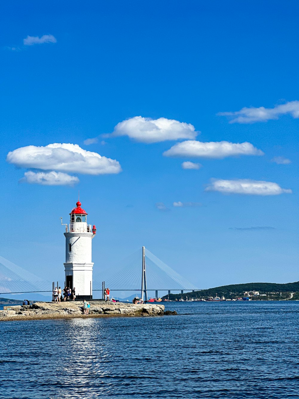 a lighthouse on a small island in the middle of the ocean