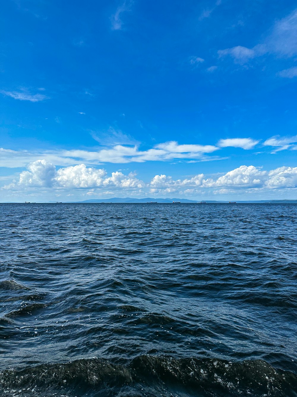 a body of water with a boat in the distance