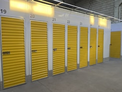 a row of storage units with yellow doors