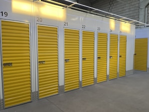 a row of storage units with yellow doors