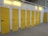 a row of storage units with yellow doors