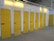 a row of storage units with yellow doors