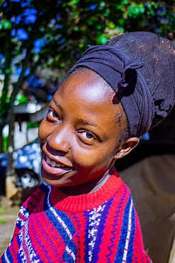 A warm, inviting photo of Dr. Ekus smiling gently in an olive green setting.