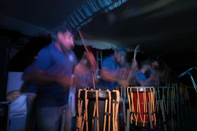 Close-up of traditional African drums being played with energetic hands, blending old rhythms with new beats.