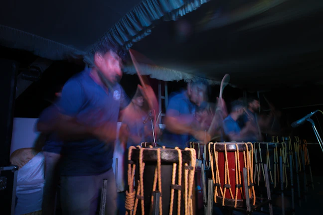 A vibrant image of a berimbau being played in a capoeira class.