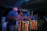 Close-up of Batukanum percussionists playing vibrant drums under warm stage lights.