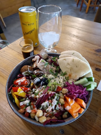 A colorful bowl of shawarma, garnished with fresh vegetables.